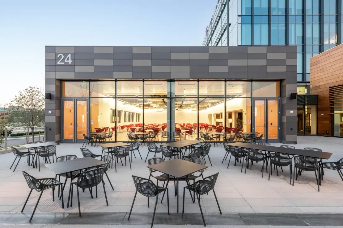 Fiber cement rainscreen cladding around a completed plaza-facing building elevation