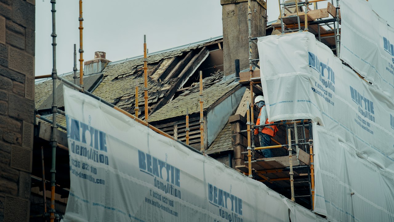 Continuous exterior insulation installed behind a rainscreen cavity to improve energy efficiency and wall drying